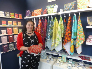 Above: Joanne de Pace with her eponymous collection, including colourful beeswax food wrap and tea towels.
