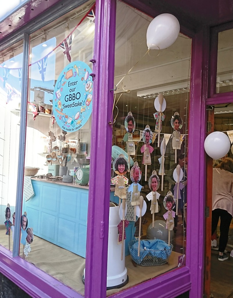 Above: The Bake-Off window contained a mock-up of a bake-off station similar to those on Channel 4’s The Great British Bake Off. It changed week by week as The Woodbridge Kitchen Company emulated some of the judges’ challenges and displayed product suited to that week’s theme. The window ran alongside a sweepstake (or ‘sweetstake’) so customers could guess the eventual winner. Contestants were pictured on wooden spoons in the window, which were turned around when they went out of the show.