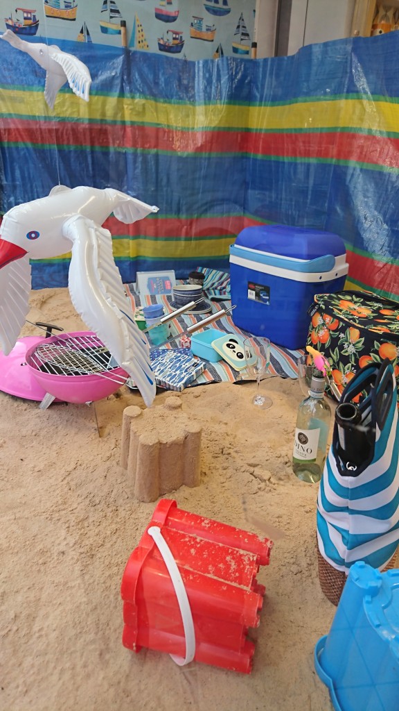 Above: Featuring real sand the Summer Beach window laid out a beach picnic scene with sand, seagulls, windbreak and a bbq.