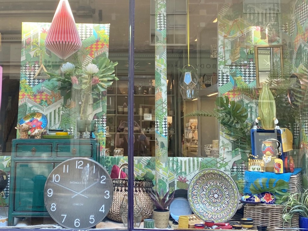 Above: One of Rossiters of Bath’s reopening series of Summer Brights Windows; the building’s historic pillars became part of the colourful theme.